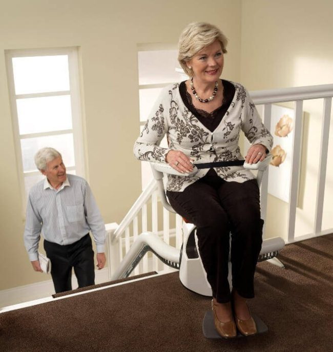 Person Sitting on The Flow2 Indoor Curved Rail Stairlift